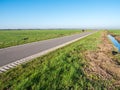 Asphalt road heading to horizon in rural polder landscape of Eempolder, near Eemnes, Netherlands Royalty Free Stock Photo