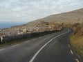 Small asphalt road in Burren National park, Mountains on the right, Atlantic ocean on the left, Part of Wild Atlantic Way