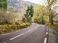 Small asphalt road with stunning nature scenery in county Kerry, Ireland. Amazing Irish landscape by a popular travel rout for Royalty Free Stock Photo