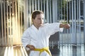 A small athlete trains a punch in karategi