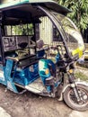 The small auto rickshaw is named Tom Tom auto