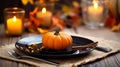 Small autumn pumpkins on a plate, table setting