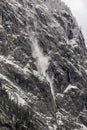 Small avalanche between trees on steep rock Royalty Free Stock Photo