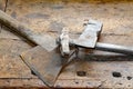 small axe and big hammer on the old wooden workbench Royalty Free Stock Photo