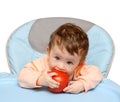 Small baby biting tomato