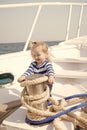 Small baby boy with happy face on boat with rope Royalty Free Stock Photo