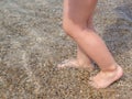 Baby feet close-up on the sand of the sea beach. Sea water washes the feet. Happy childhood. Rest at the sea. Summer Royalty Free Stock Photo