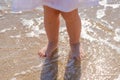 Baby feet close-up on the sand of the sea beach. Sea water washes the feet. Happy childhood. Rest at the sea. Summer Royalty Free Stock Photo