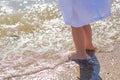 Baby feet close-up on the sand of the sea beach. Sea water washes the feet. Happy childhood. Rest at the sea. Summer Royalty Free Stock Photo