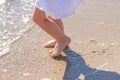 Baby feet close-up on the sand of the sea beach. Sea water washes the feet. Happy childhood. Rest at the sea. Summer Royalty Free Stock Photo