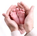 Small baby feets lying on a father`s hands