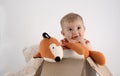 Small baby girl in a box with teddies