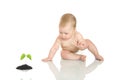 Small baby with green plant #4 Royalty Free Stock Photo