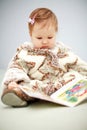 Small baby reading a book