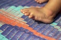 A small baby's foot on the Plastic mat and its background blur