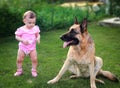 Small baby serious looking on dog