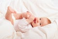 Small baby sucking her finger on leg Royalty Free Stock Photo