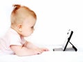 Small baby using tablet pc on white