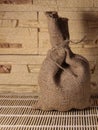 A small bag on a beige background. A canvas bag on a wooden Mat