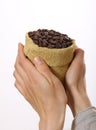 Small bag of coffee beans in female hands