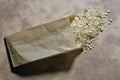 Small bag of grocer`s paper with barley and spelled rice grains Royalty Free Stock Photo