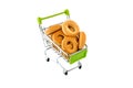 Small bagels in a metal shopping trolley isolated on white.