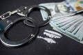 small bags of drugs and US dollar bills with handcuffs and bullets from a gun. Royalty Free Stock Photo