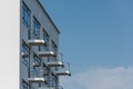 Small balconies on the Bauhaus building in Dessau on clear day with blue sky