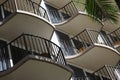 Small balconies with palm frond on tropical apartments, hotel or resort