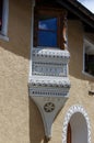 Ancient balcony with wooden windows - Zuoz village Engadine Switzerland Royalty Free Stock Photo