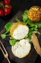 Small balls of Swiss hard cheese Belper Knolle, made from cow`s milk. A cut fresh ball of cheese lies on a beautiful wooden