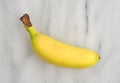 Small banana on a marble cutting board