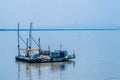 Small barge with yellow crane moored in harbor Royalty Free Stock Photo