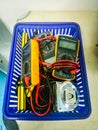 A small basket full of unused multi-meter on a table. Used to detect the value of electrical voltage and current in the circuit. Royalty Free Stock Photo