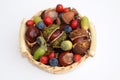 Small basket with horse chestnuts, acorns, rose hips and sloes Royalty Free Stock Photo