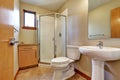 Small bathrom interior with sink, toilet, shower and tile floor.