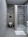 A small bathroom with a shower and a toilet.