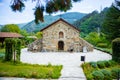 Small beautiful church in Bulgaria in the mountain. Green hills with forests and trees behind it. Royalty Free Stock Photo