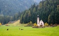 The church of Saint John, Ranui, Chiesetta di san giovanni in Ranui Runes South Tyrol Italy, surrounded by green meadow, forest