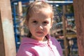 small beautiful European girl 5-6 years old with a pigtail on her head, with large brown beautiful eyes,