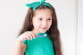 Small beautiful girl cleans teeth toothbrush Dentistry