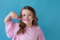 Small beautiful girl cleans teeth toothbrush Dentistry