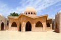 Small beautiful neat stone clay Arab Islamic Muslim houses with round domes in the desert with palm trees in a tropica Royalty Free Stock Photo