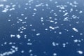 Small beautiful snowflakes lie on a smooth surface