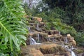 Small beautiful stepped waterfall in the tropics in Israel Royalty Free Stock Photo