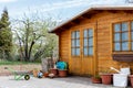 Small beautiful wooden house shed or storage hut for garden tools equipment and bicycles at backyard at beautiful Royalty Free Stock Photo