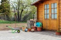 Small beautiful wooden house shed or storage hut for garden tools equipment and bicycles at backyard at beautiful