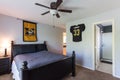 Small bedroom in white and black colors decorated with missouri tigers basketball poster