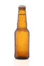 small Beer bottle with water drops isolated on white Royalty Free Stock Photo