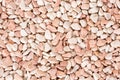 Small beige color round pebbles gravel background texture.